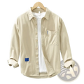 Beige men’s solid long sleeve casual button-up shirt with rolled cuffs chest pocket and blue fabric patches on left side