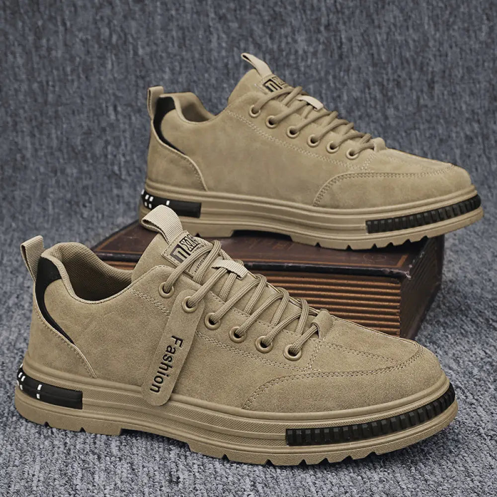 Luxury men’s rugged platform sneakers in tan suede with black accents and chunky sole featuring fashion tag