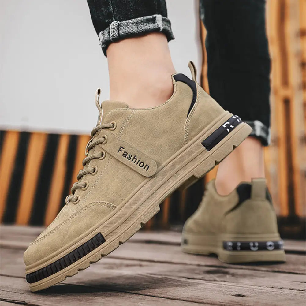 Luxury men’s rugged platform sneakers in tan suede with black accents and chunky rubber sole for breathable sport use