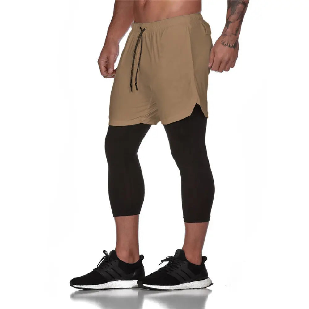 Men’s camouflage quick dry tan two-in-one training shorts with drawstring waist layered over black leggings