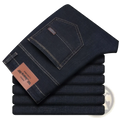 Men’s dark blue stretch cotton straight jeans with white stitching and brown leather brand tag for casual wear