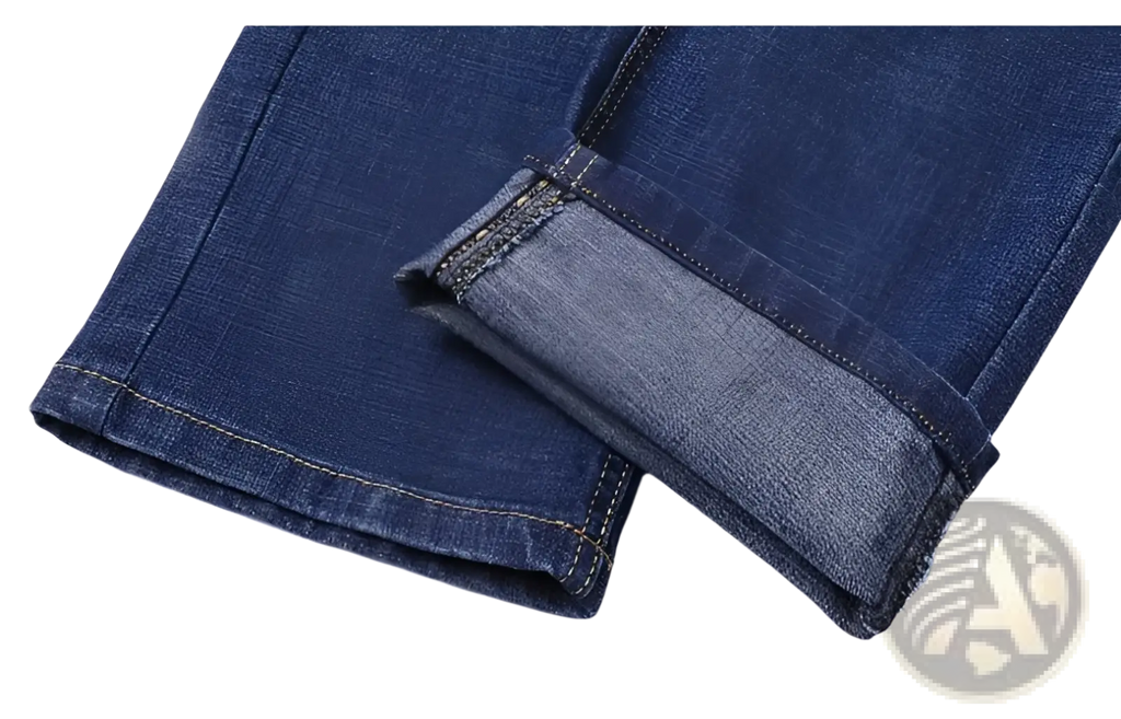 Men’s stretch cotton straight dark blue denim jeans with rolled cuffs revealing lighter inner fabric and contrast stitching