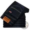 Mens stretch denim jeans slim fit casual pants in dark indigo with white stitching and brown leather brand patches back view