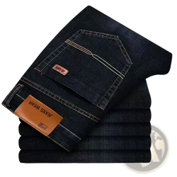 Mens stretch denim jeans slim fit casual pants in dark indigo with white stitching and brown leather brand patches back view