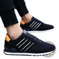 Men’s suede athletic fashion sneakers in black with white stripes and orange heel accents for sizes 39 to 44