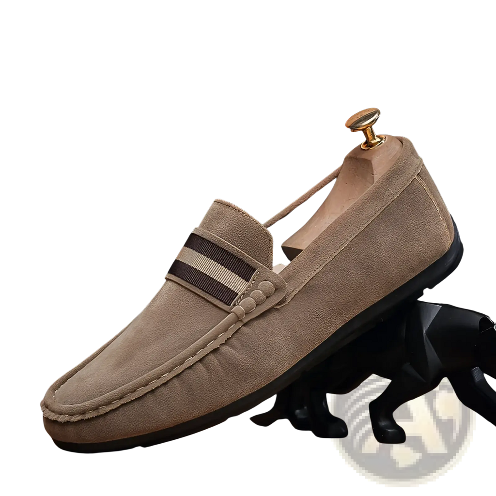 Men’s tan suede loafers with brown and beige striped strap featuring metal buckle and rubber sole
