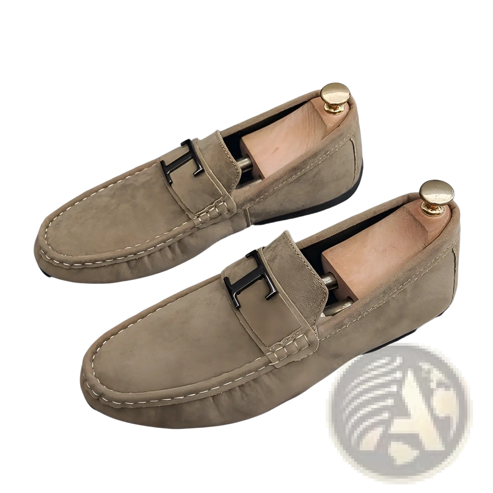 Men’s beige suede loafers with black metal h buckle and contrasting white stitching featuring a rubber sole