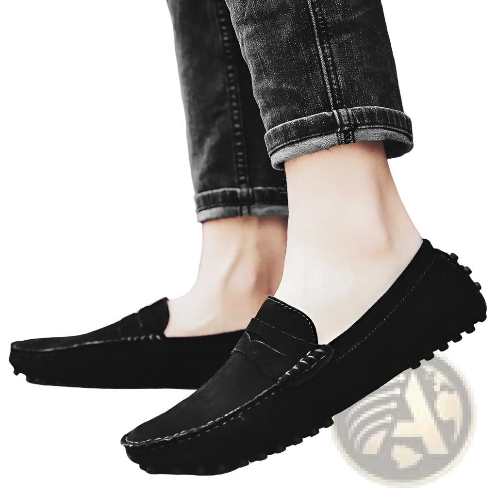 Men’s black suede moccasin loafers with classic design and textured rubber soles displayed from the back side