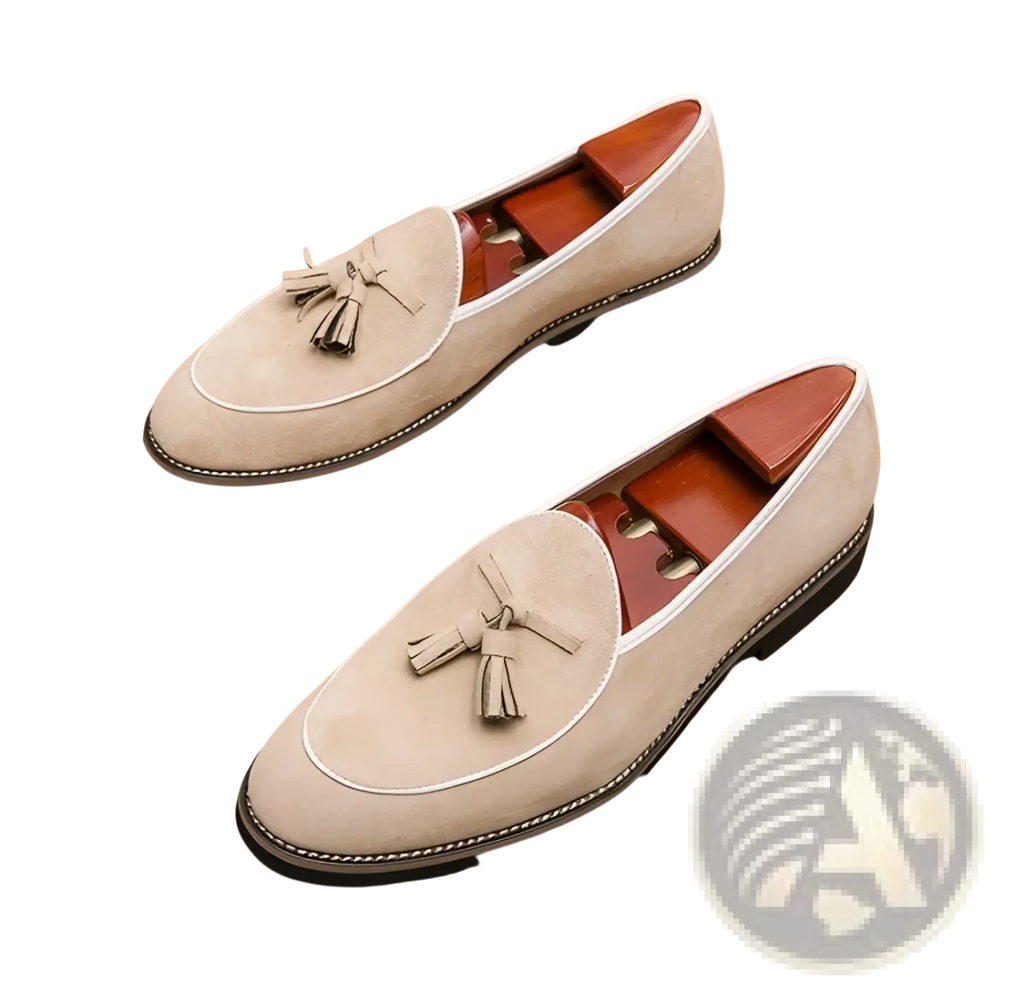 Beige men’s suede tassel loafers with white stitching and black rubber sole made from matte cowhide leather