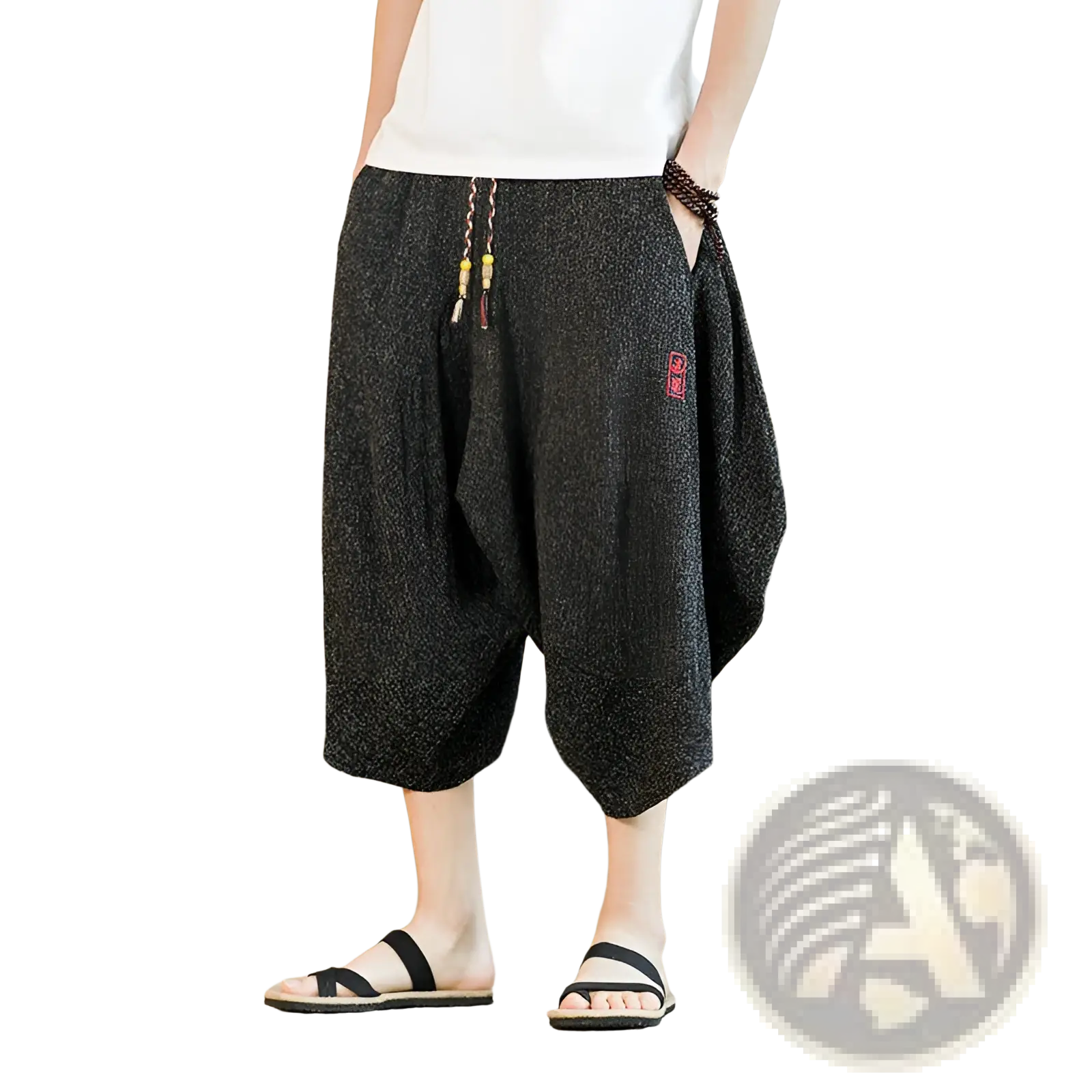 Men’s black textured cotton wide leg lantern harem shorts with drawstring waist and red embroidered patch