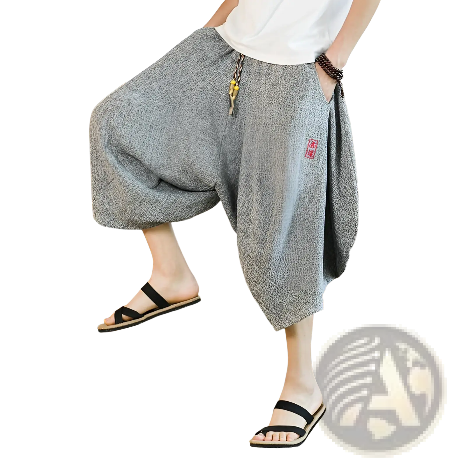 Men’s gray textured cotton wide leg lantern harem shorts with red embroidered patch and decorative tassels at the waist