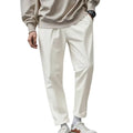 Cream-colored slim-fit men’s lightweight quick dry jogger pants made of cotton with subtle crease and rolled cuffs