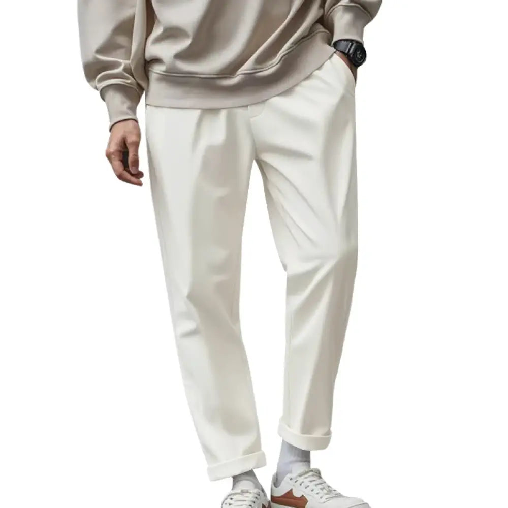 Cream-colored slim-fit men’s lightweight quick dry jogger pants made of cotton with subtle crease and rolled cuffs