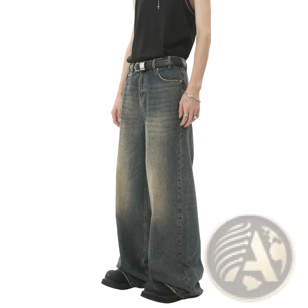 Men’s vintage wide leg baggy denim jeans in faded dark wash with subtle distressing and raw hem in front view