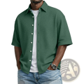 Dark green men’s waffle knit short sleeve polo shirt with white buttons and textured fabric