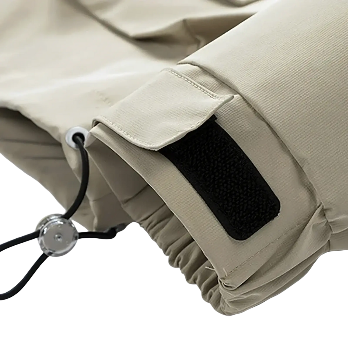 Beige cargo pants cuff with black velcro patch and adjustable drawstring paired with mens waterproof casual hooded jacket