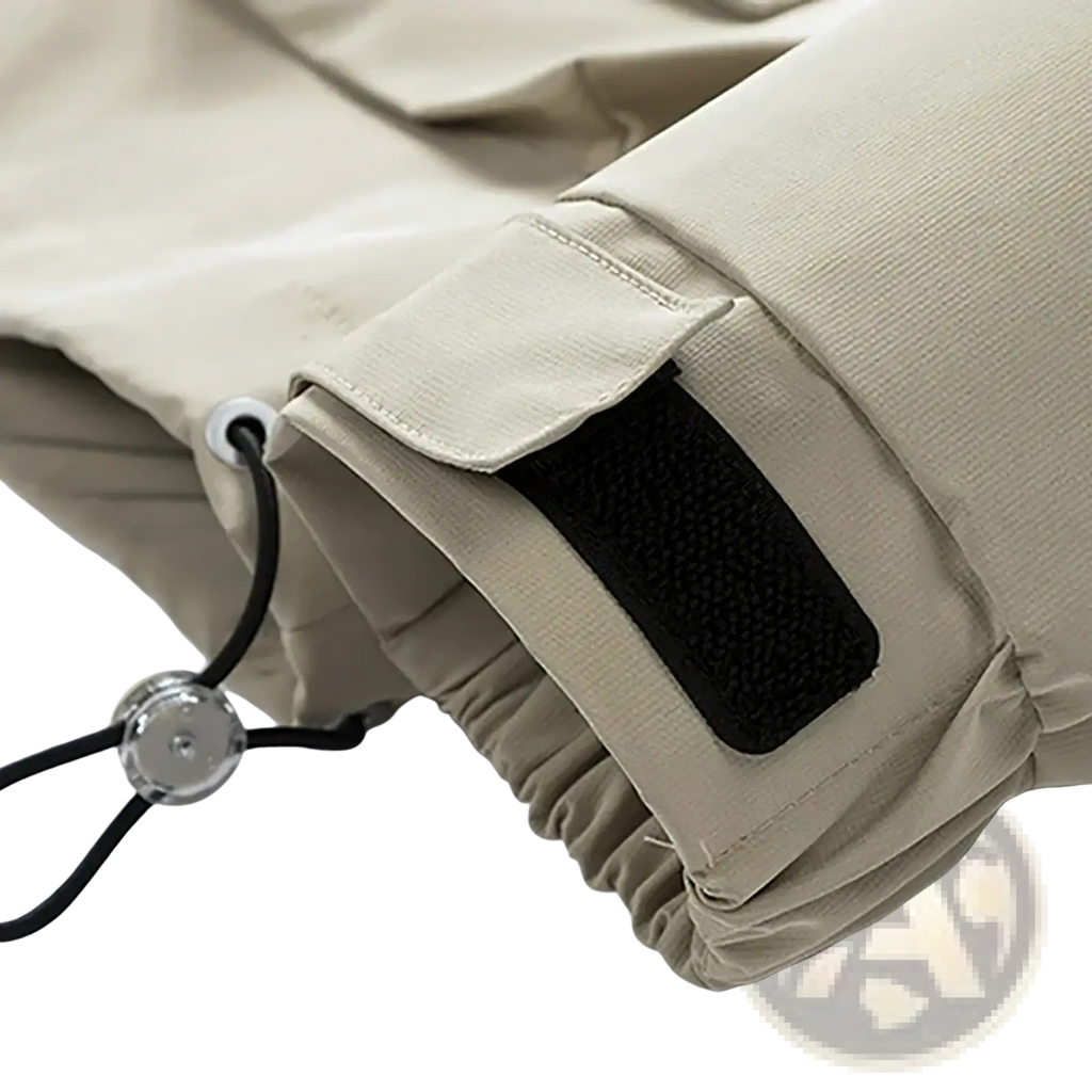 Beige cargo pants cuff with black velcro patch and adjustable drawstring paired with mens waterproof casual hooded jacket