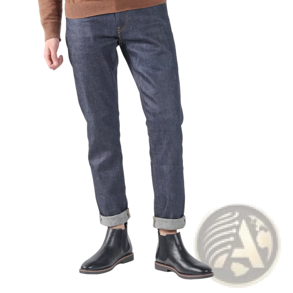 Dark indigo denim jeans with subtle textured pattern and rolled cuffs paired with men’s waterproof leather chelsea boots with tan sole
