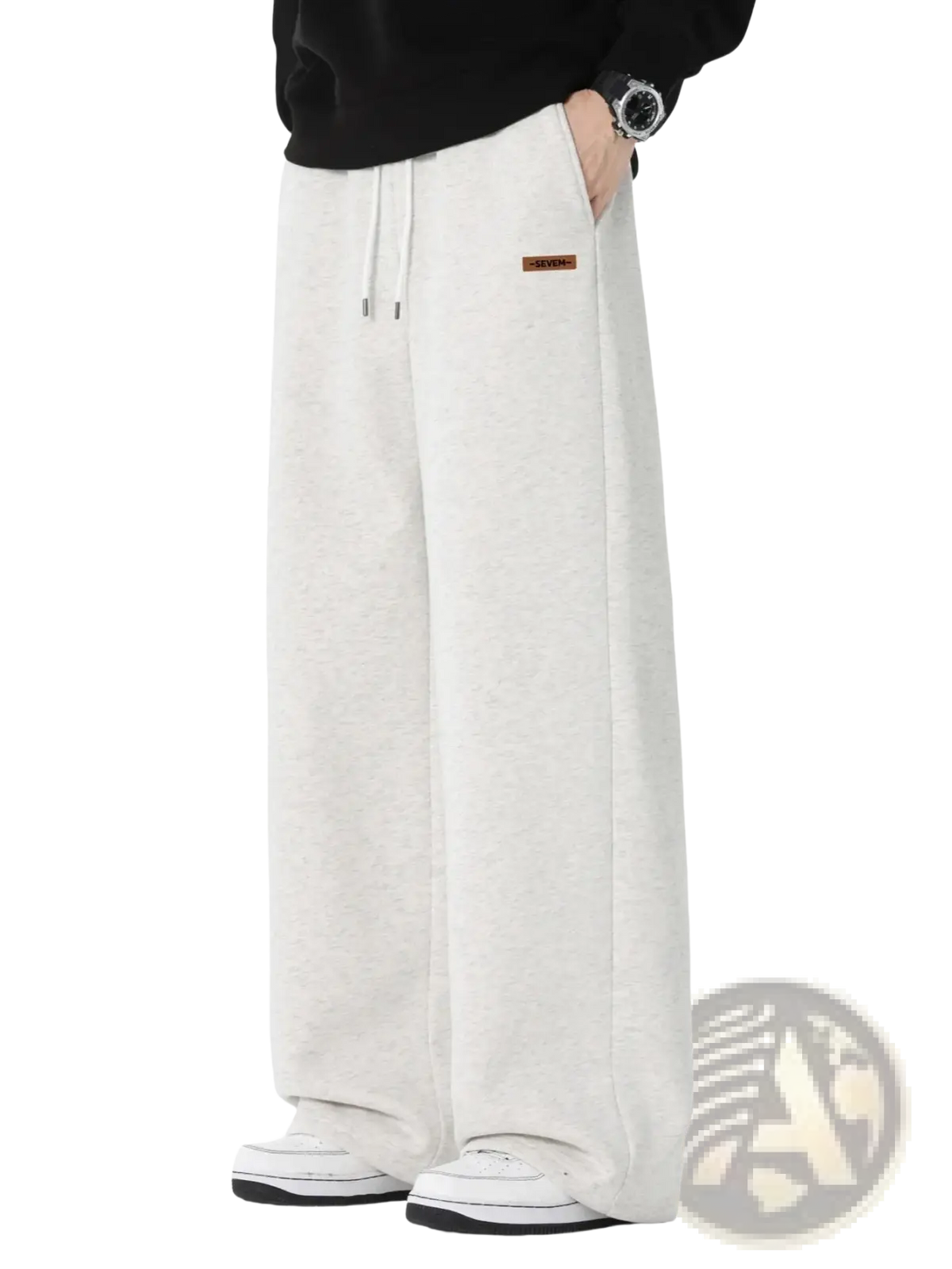 Men’s cream-colored wide leg drawstring sweatpants with loose fit and brown label on left thigh for casual wear