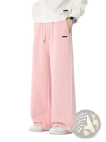 Men’s soft pink wide-leg cotton sweatpants with drawstring waist and brown label on left thigh for casual wear