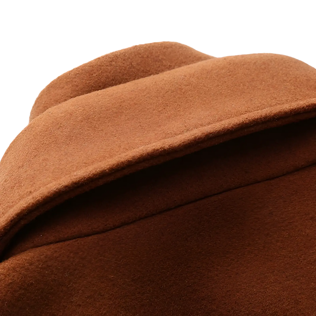 A rich brown woolen hat with soft textured surface and neat stitching complementing a men’s wool blend quilted winter coat