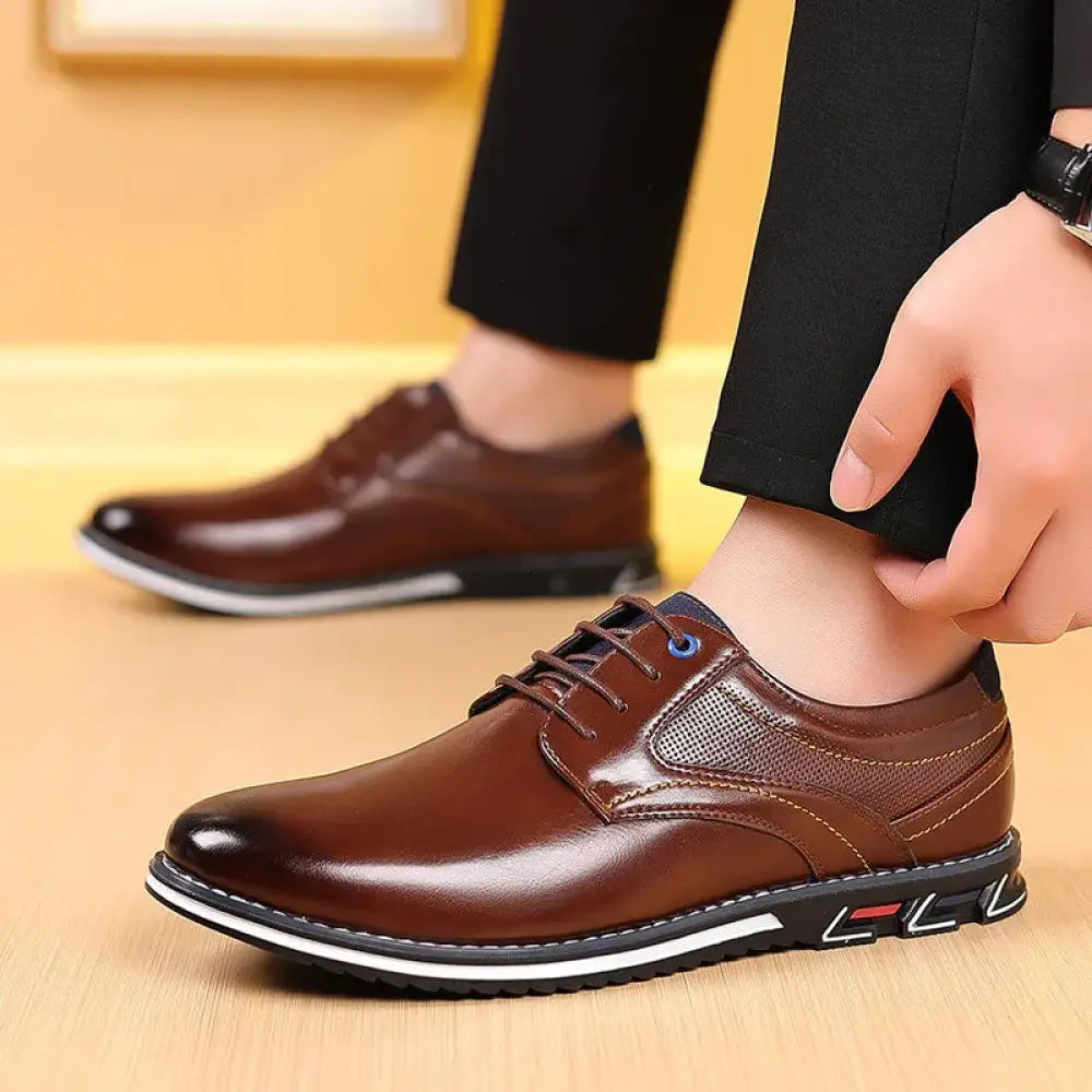Men’s brown polished leather lace up work shoes with mesh panel and black rubber sole with white stitching