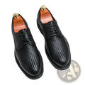 Men’s black woven leather platform British dress shoes with textured pattern and gold-toned shoe trees