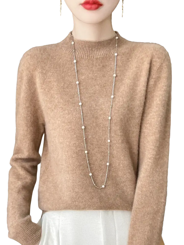 A soft beige cashmere sweater with ribbed crew neckline and long sleeves in a merino wool pullover style for women