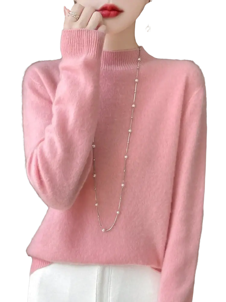 A soft pink merino wool pullover sweater for women with long sleeves and ribbed neckline and cuffs