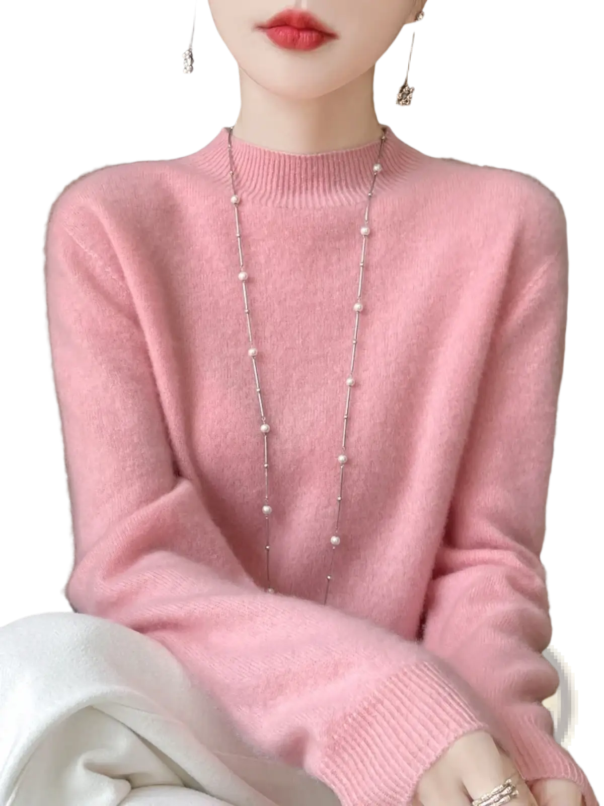 A soft pink merino wool pullover sweater for women with long sleeves and ribbed crew neckline and cuffs