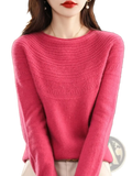 A soft vibrant pink merino wool sweater for women featuring a textured knit pattern on chest and shoulders