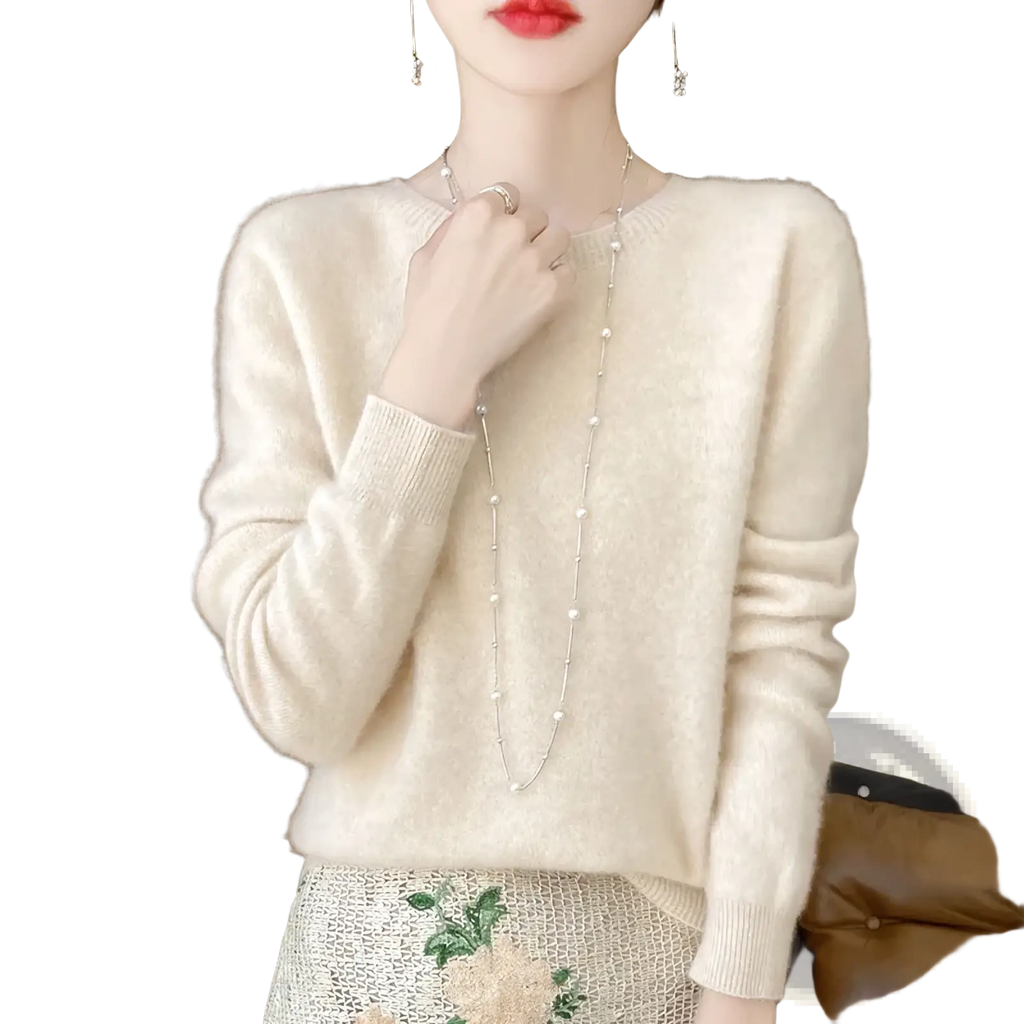 Cream-colored merino wool sweater for women with soft knit texture, long sleeves, and o-neck pullover design