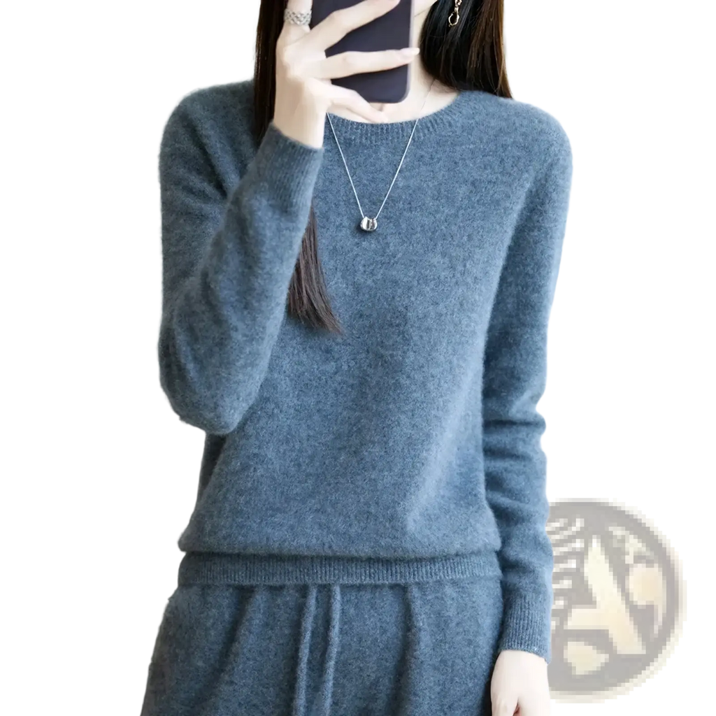 A soft heathered gray merino wool women O-neck pullover sweater with ribbed cuffs and round neckline