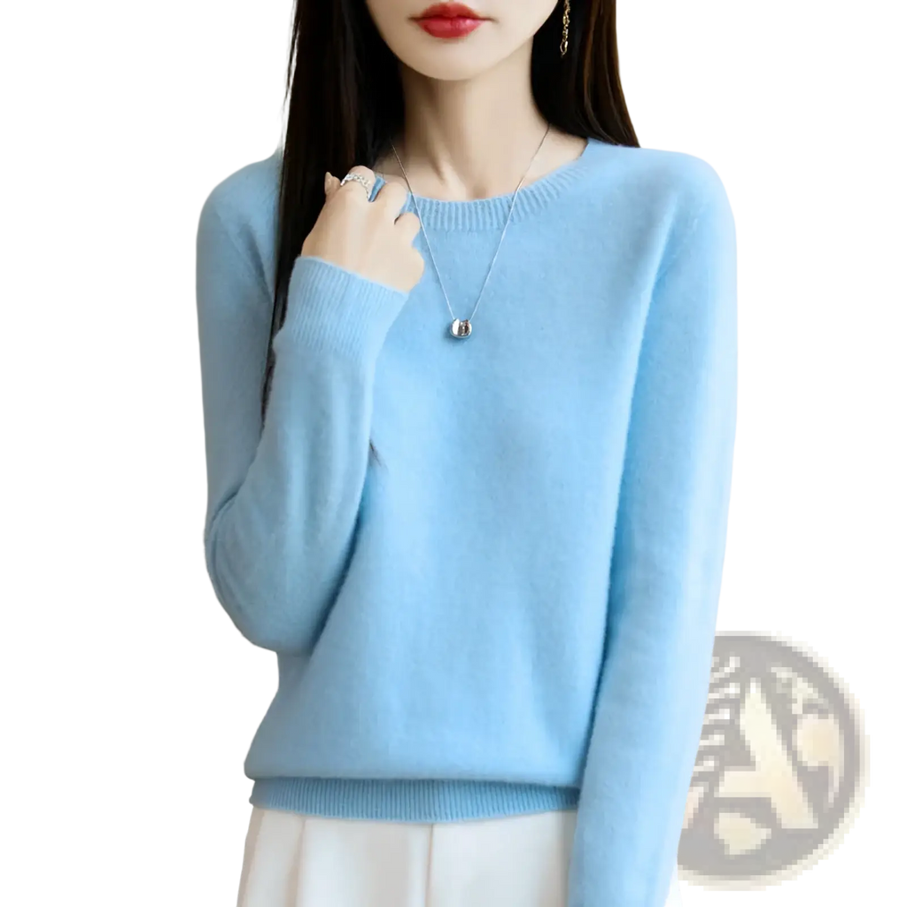 A soft light blue merino wool sweater for women with o-neck pullover and ribbed cuffs is displayed
