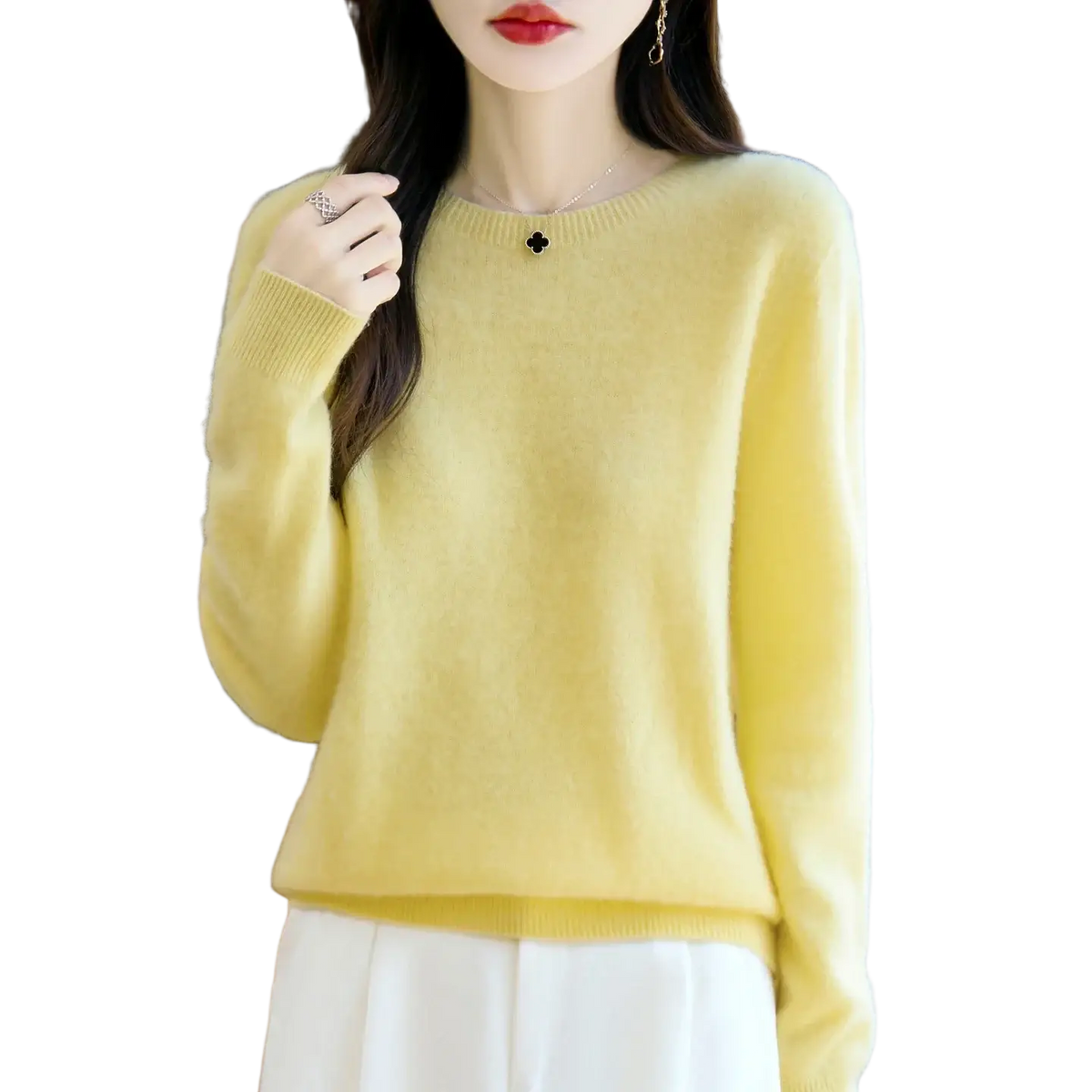 A soft pale yellow merino wool sweater for women with a round neckline and ribbed cuffs in a pullover style