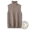 A soft beige merino wool turtleneck sleeveless knit vest with ribbed hem and neckline for layering
