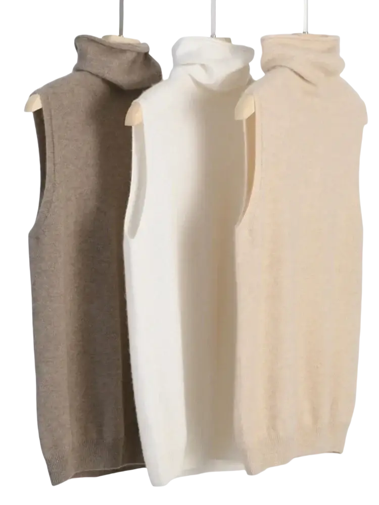 Three sleeveless merino wool turtleneck knit vests in beige cream and taupe displayed on wooden hangers