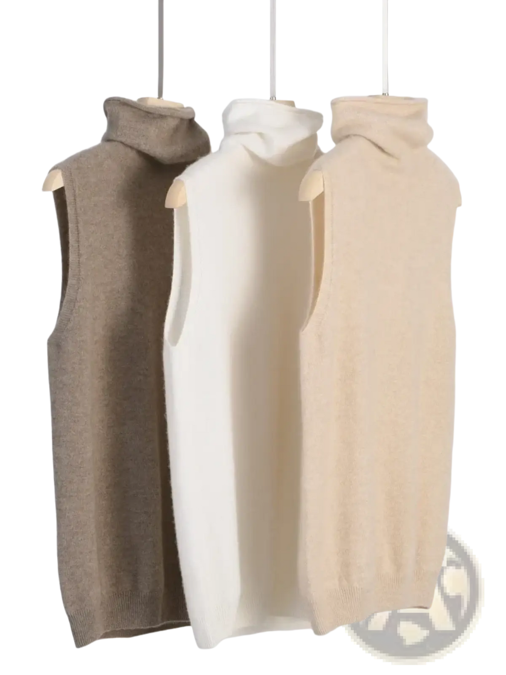 Three sleeveless merino wool turtleneck sweater vests in beige cream and taupe displayed on wooden hangers