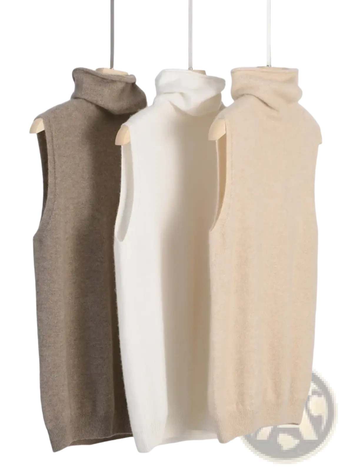 Three sleeveless merino wool turtleneck sweater vests in beige cream and taupe displayed on wooden hangers