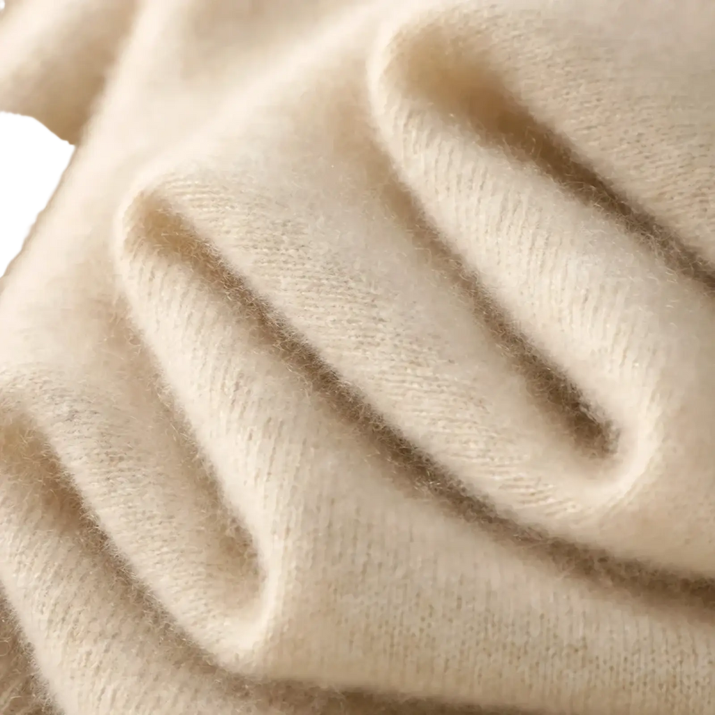 Cream-colored soft fluffy knit merino wool turtleneck vest fabric with a subtle textured weave