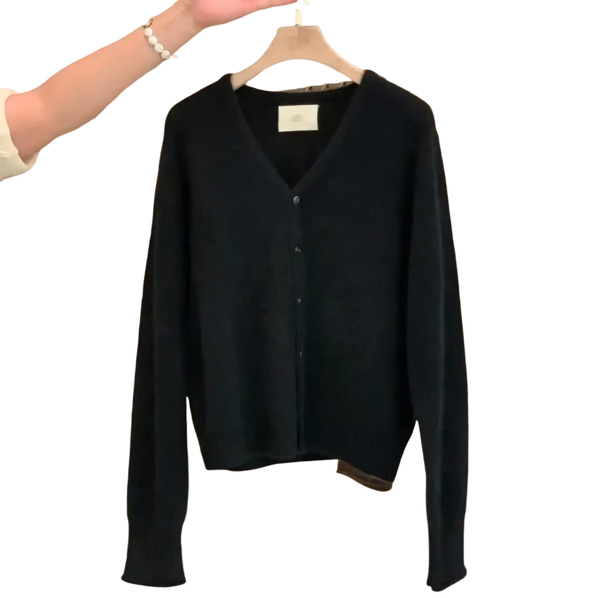 Black merino wool v-neck cardigan sweater with long sleeves and button closure for versatile layering