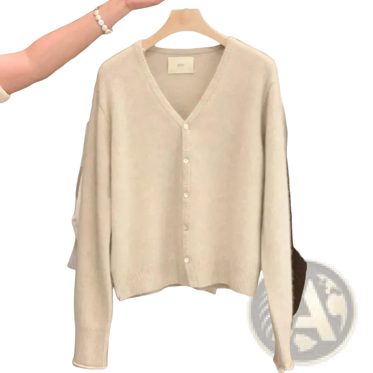 Merino wool v-neck cardigan sweater in soft off-white with long sleeves and button-front closure