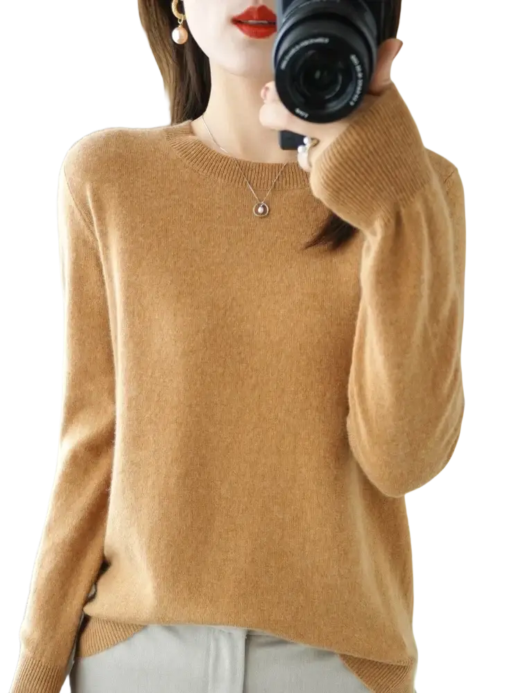 A camel-colored soft cashmere sweater with round neckline and ribbed cuffs for women casual wear