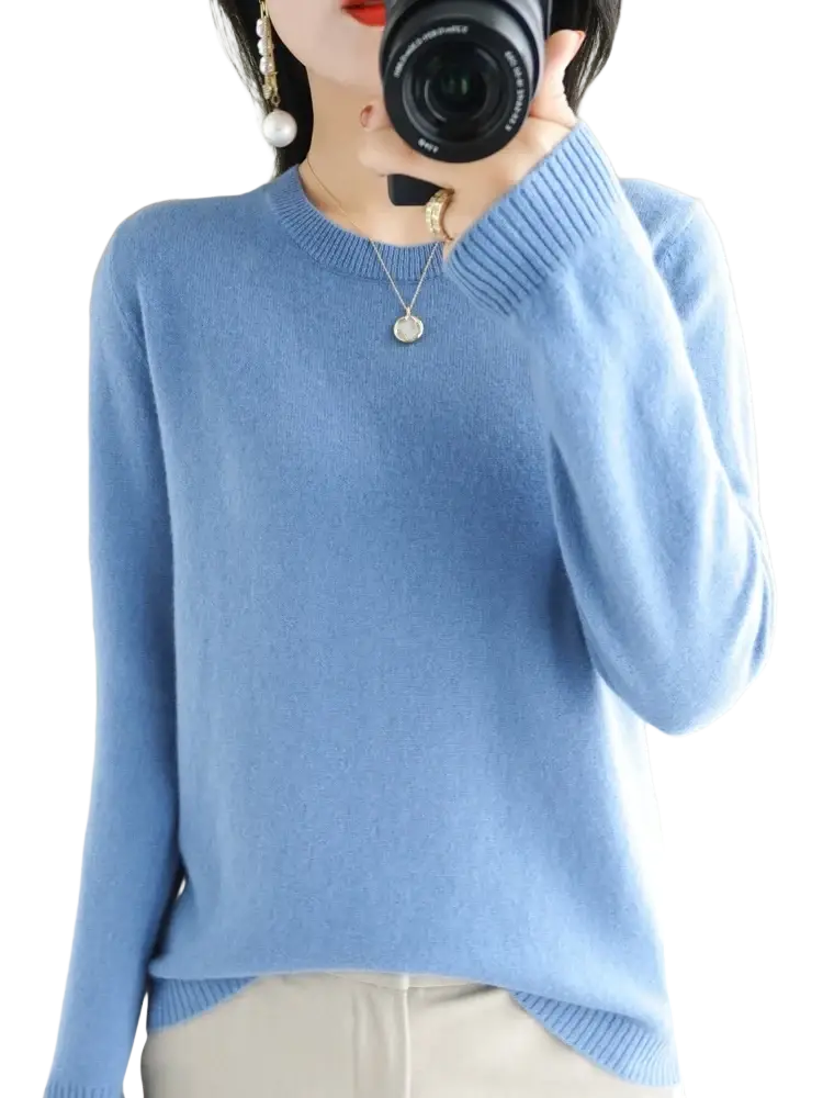 A soft light blue merino wool women casual pullover sweater with round neckline and ribbed cuffs