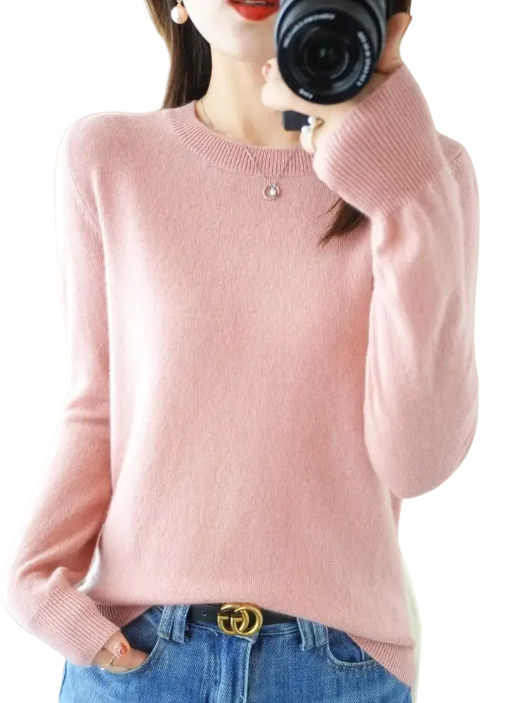 A soft pink merino wool women casual pullover sweater with long sleeves and ribbed crew neckline and cuffs