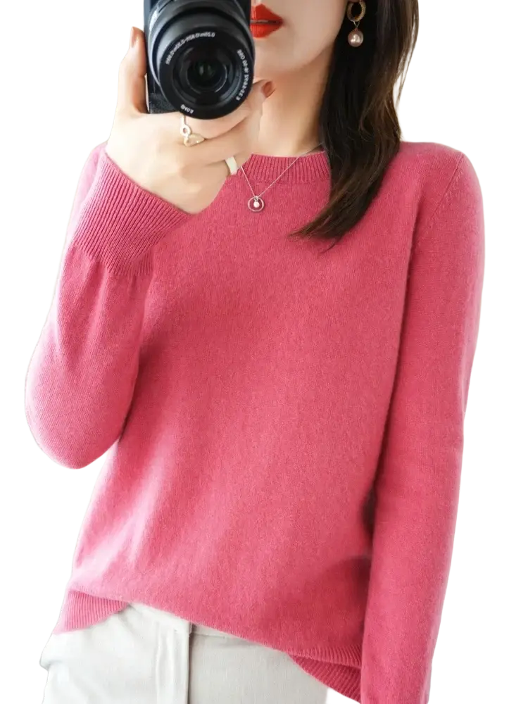 A soft pink merino wool women casual pullover sweater with long sleeves ribbed neckline and cuffs
