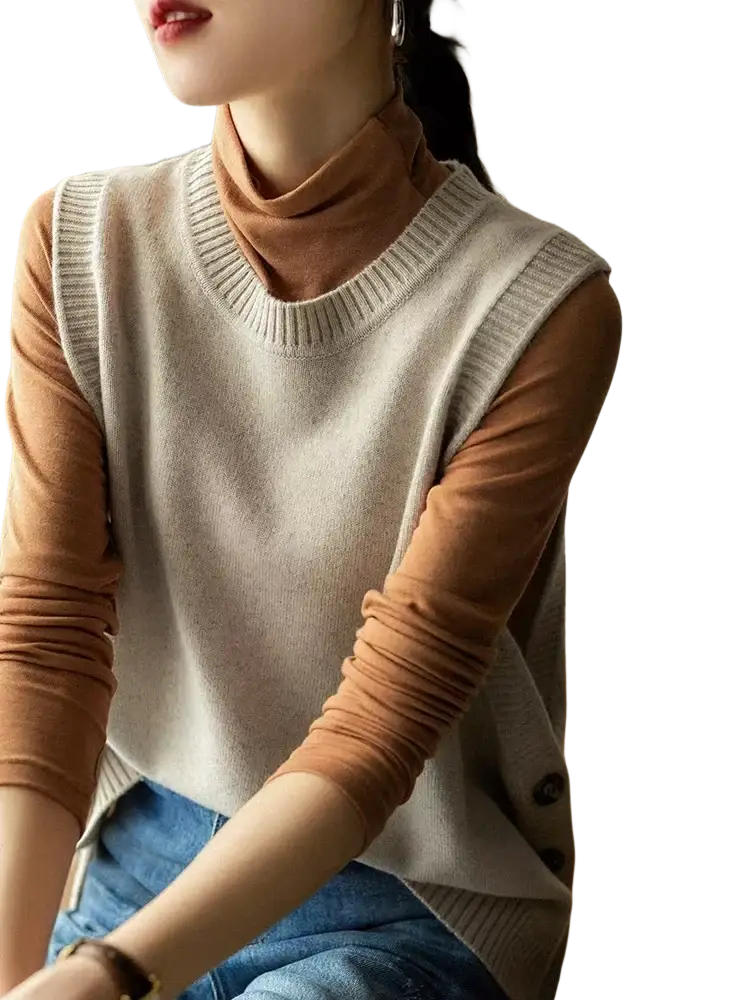 Beige merino wool knitted sleeveless sweater vest worn over rust-colored turtleneck for women