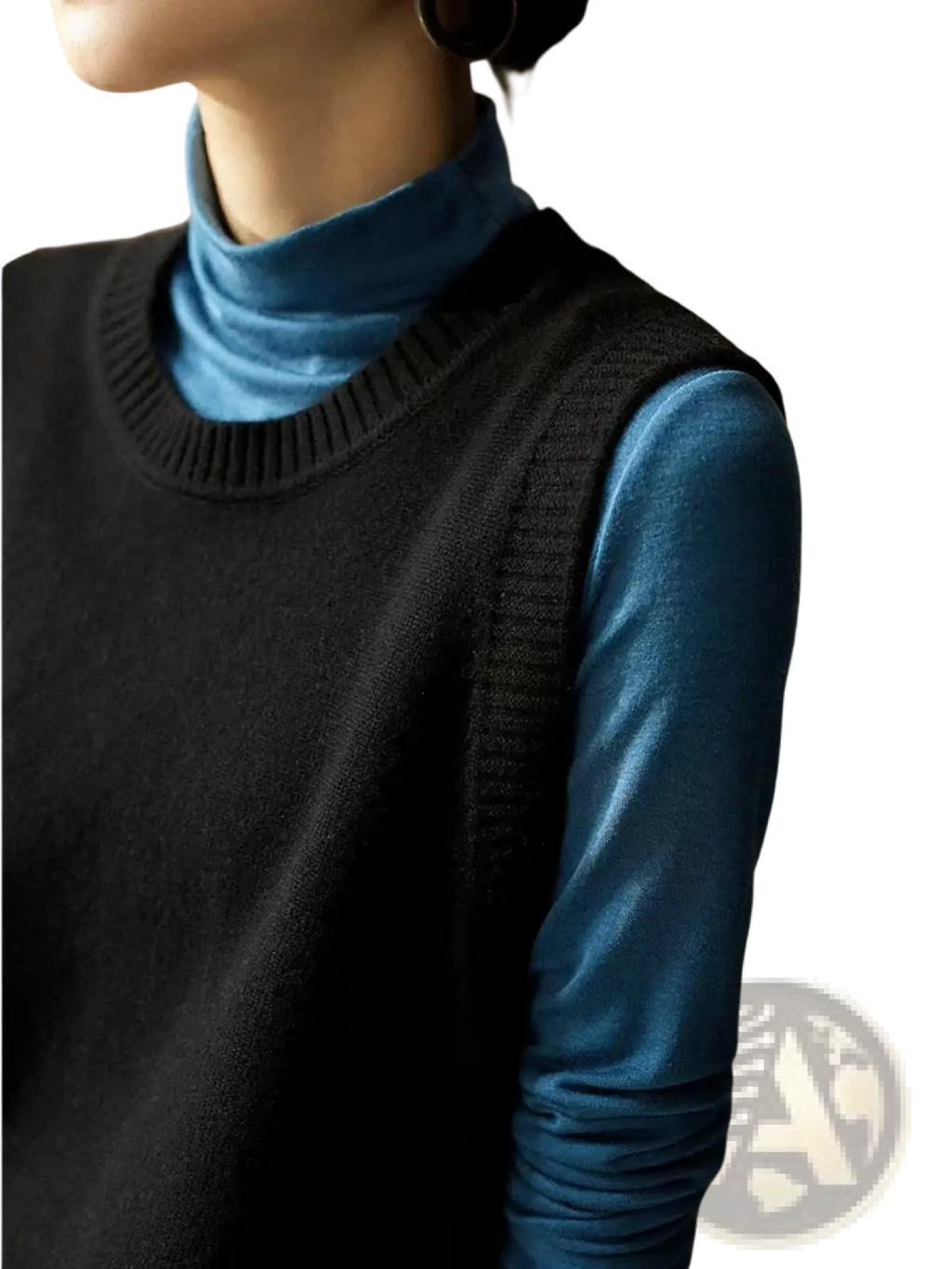 Black knitted sleeveless merino wool women sweater vest worn over a blue turtleneck top for layering warmth