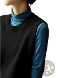 Black knitted sleeveless merino wool women sweater vest worn over a blue turtleneck top for layering warmth