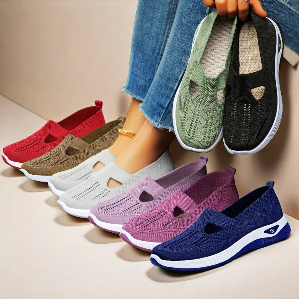 A pair of women’s breathable mesh slip on casual flats in navy blue knit with white and blue soles and t shaped cutout design